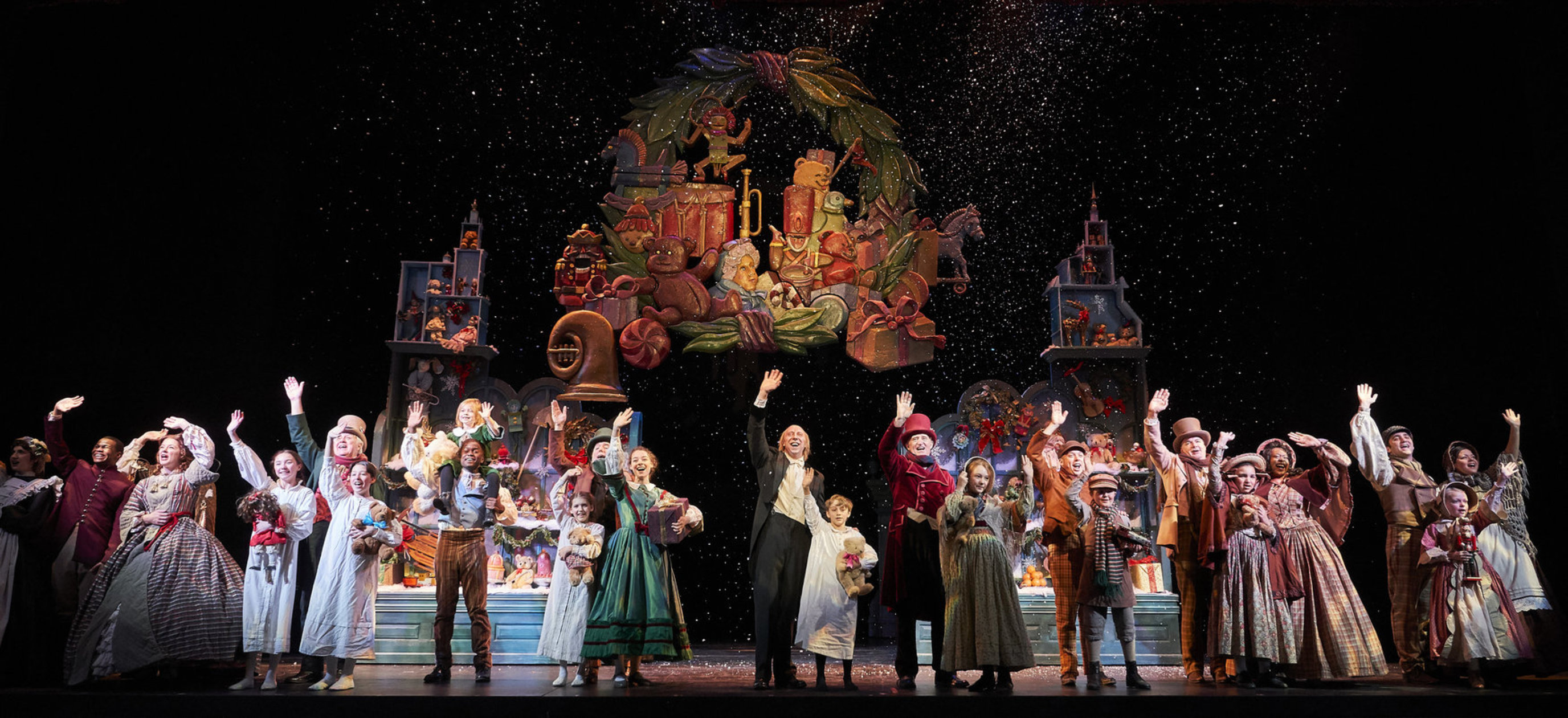 Actors on stage waving as snow falls2
