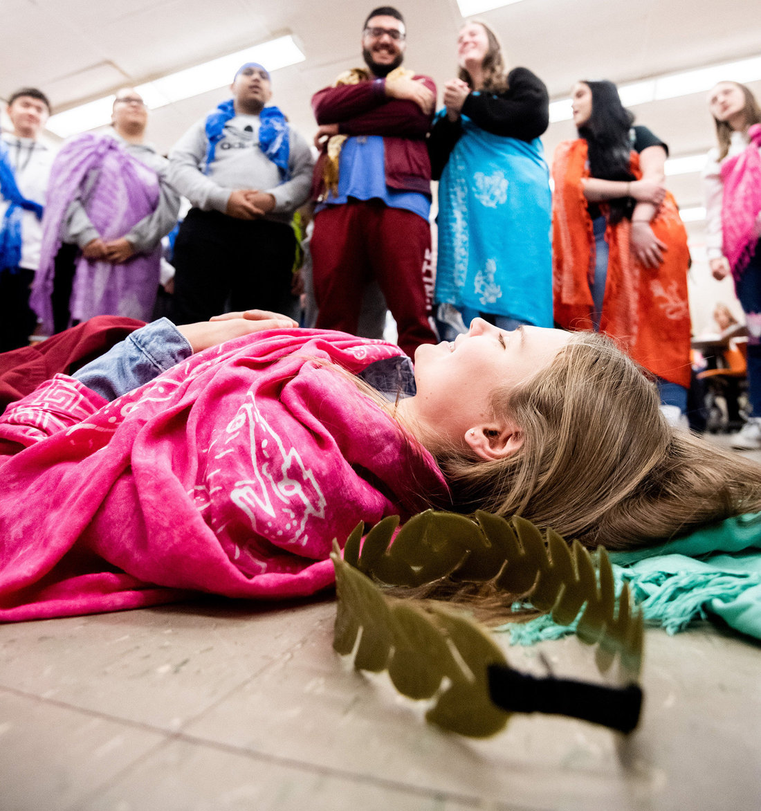 Girl laying on ground with people above her2