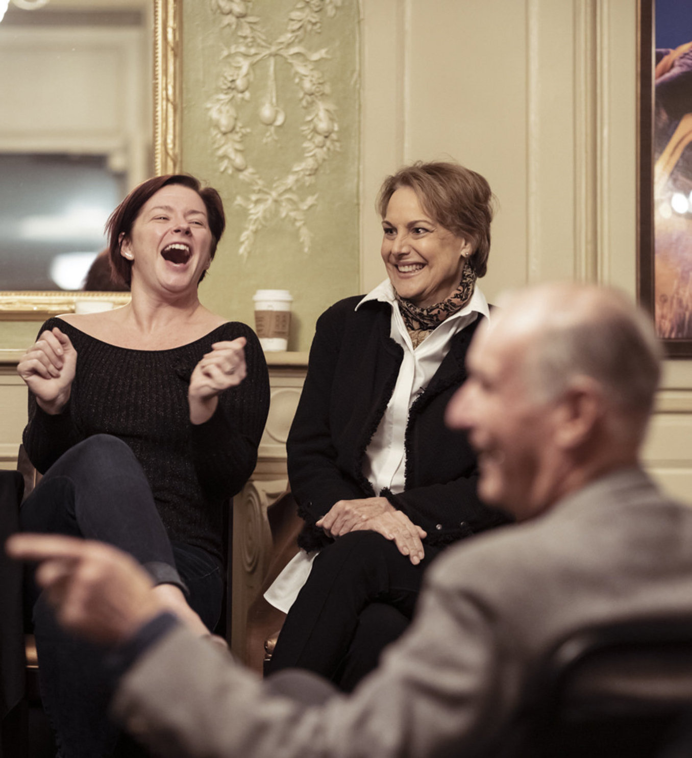 Two actors smiling laughing in front of crowd