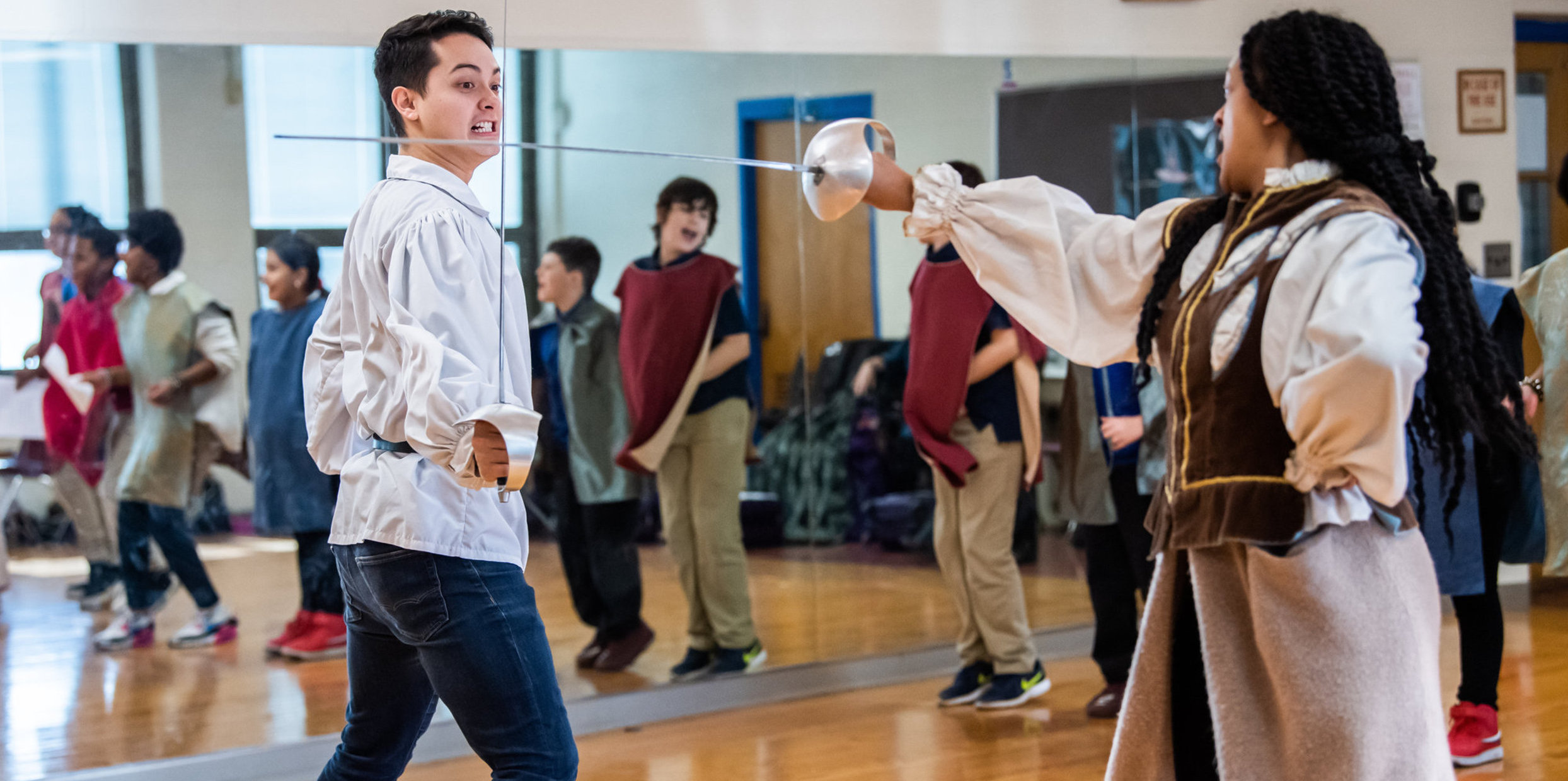 Two people fencing
