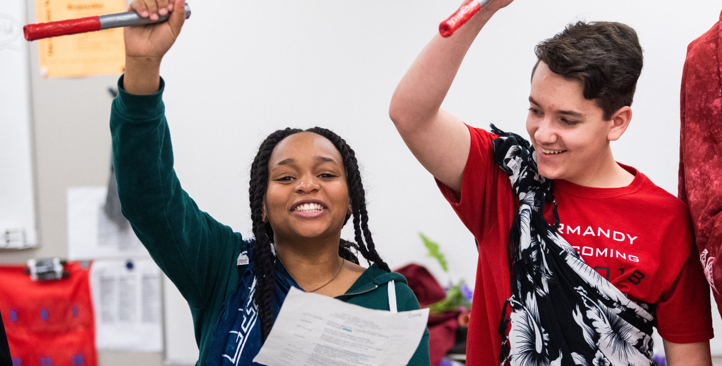 Two students holding sticks